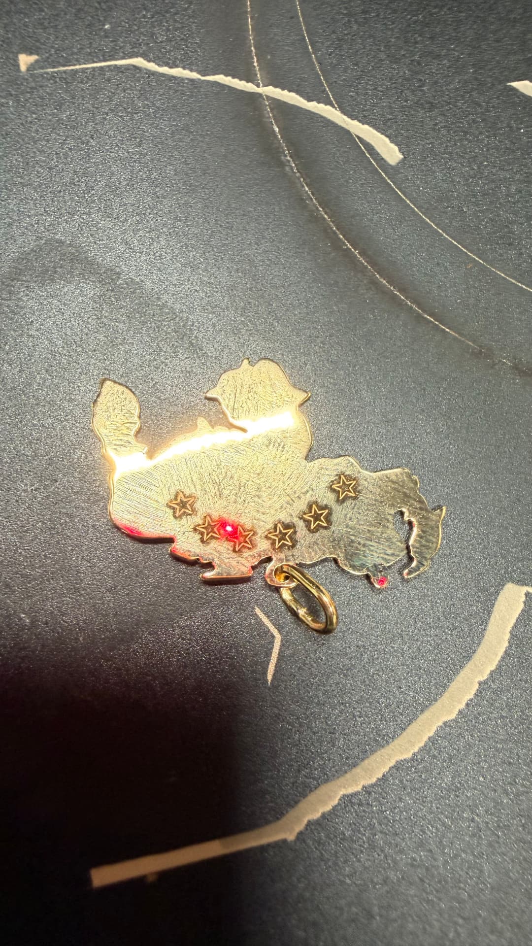 Brass pendant being engraved on the fiber laser